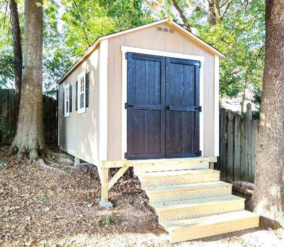 Shed on uneven ground with accent color on the door